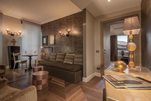 a living room with a couch and a table at Hotel Palazzo Manfredi – Small Luxury Hotels of the World in Rome