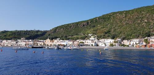 a group of boats in a body of water with houses at Zagma Un Passo Dal Mare in Canneto