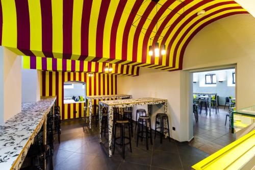 a restaurant with yellow and red striped ceiling at Youth Hostel Würzburg in Würzburg