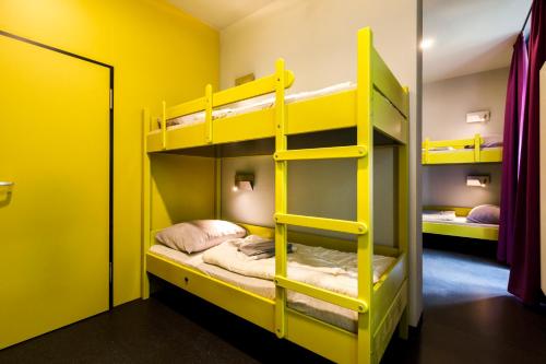 a bunk bed room with yellow bunk beds at Youth Hostel Würzburg in Würzburg