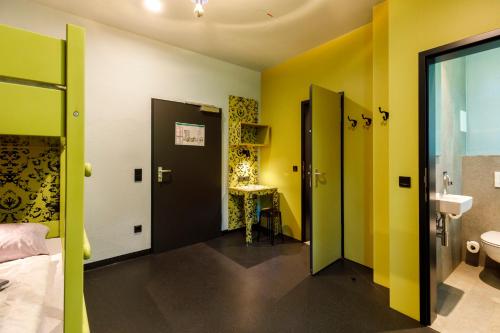 a bathroom with yellow and green walls and a sink at Youth Hostel Würzburg in Würzburg