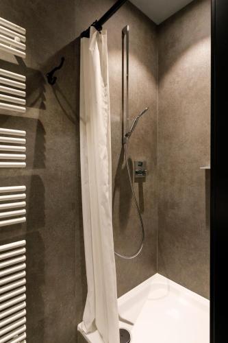 a shower with a shower curtain in a bathroom at Youth Hostel Würzburg in Würzburg