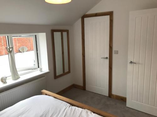 a bedroom with a bed and a window at No 4 Elizabeth Street in Congleton