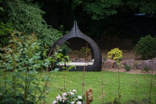 a gazebo in the middle of a garden at Ballinwillin House in Mitchelstown