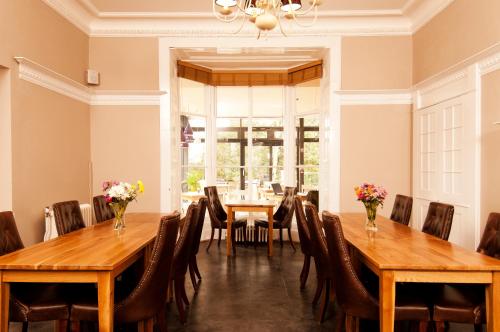 a dining room with wooden tables and chairs at YHA York in York