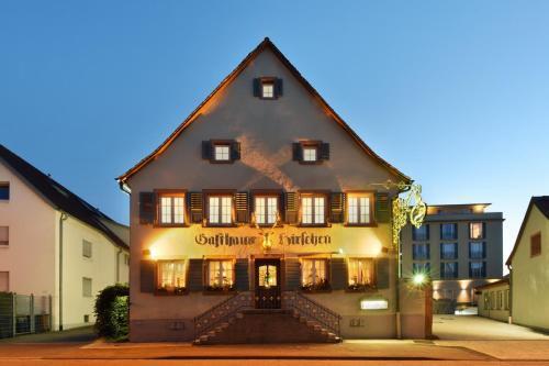 abered house in the middle of a street at Hotel Hirschen in Freiburg-Lehen in Freiburg im Breisgau