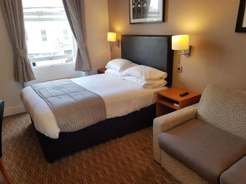 a hotel room with two beds and a television at The Wellington in Brecon