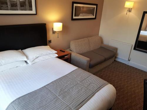 a hotel room with two beds and a lamp at The Wellington in Brecon