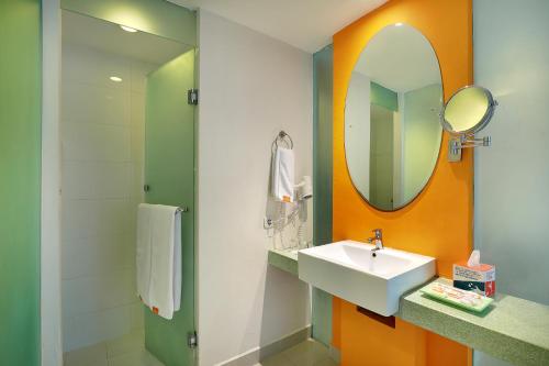 a bathroom with a sink and a mirror at HARRIS Hotel & Residences Riverview Kuta, Bali - Associated HARRIS in Kuta