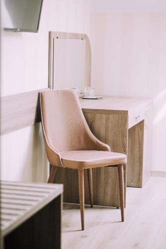 a chair in front of a desk with a mirror at Bolero plus in Mukacheve