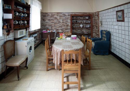 a kitchen with a table and chairs in a kitchen at Rakel in Muros