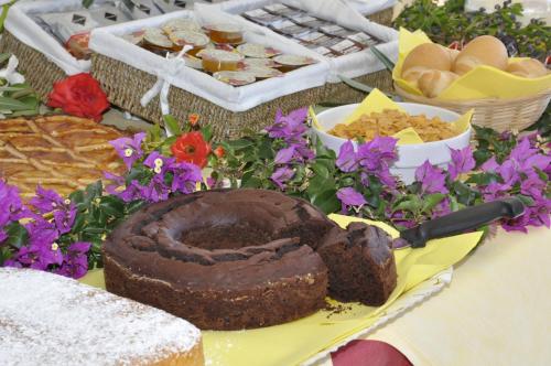 a chocolate cake sitting on a table with flowers at B&B I Graniti Sardi in Villasimius
