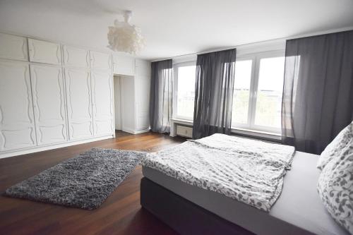 ein Schlafzimmer mit einem Bett und einem großen Fenster in der Unterkunft Dorya am Ring in Köln