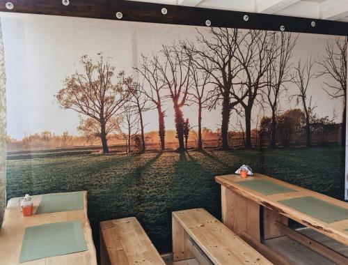 a mural of a park with two picnic tables at Suite Manzoni in Boffalora sopra Ticino