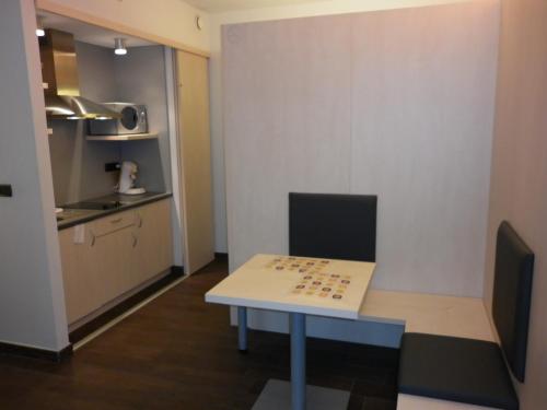 a small room with a table with a chess board on it at Ibis Styles La Louvière in La Louvière