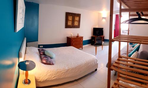 a bedroom with a bed and a bunk bed at Charmant Studio en Champagne - Sparkling-Life in Matougues