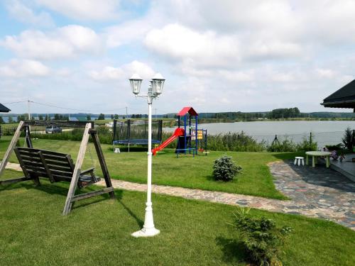 a park with a playground and a street light at Sterla - Masuria in Giżycko