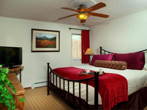 a bedroom with a bed with a red blanket at Eagle Point Resort in Vail