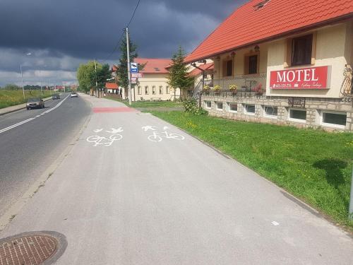 a bike lane on a road in front of a building at Motel Królowej Jadwigi in Sandomierz