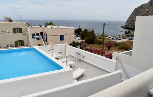 a view from the balcony of a villa with a swimming pool at Zacharakis Studios in Kamari