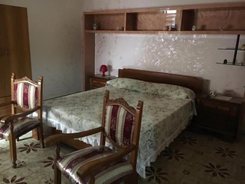Mar Ionio Apartment tesisinde bir odada yatak veya yataklar