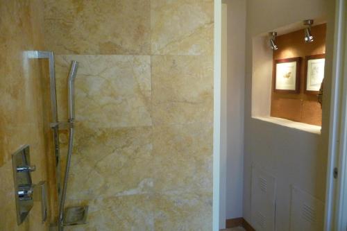 a bathroom with a shower with a glass door at Poggio ai Gelsi in Pienza