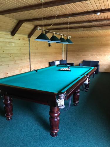 a ping pong table in a room with a pool at Georgiy in Oryavchyk
