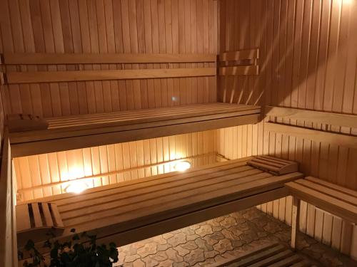 a wooden bench in a sauna with lights on it at Georgiy in Oryavchyk