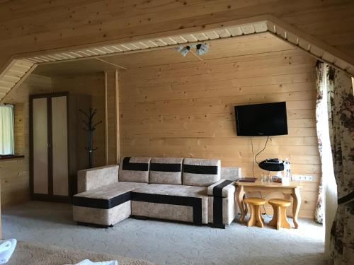 a living room with a couch and a table at Georgiy in Oryavchyk
