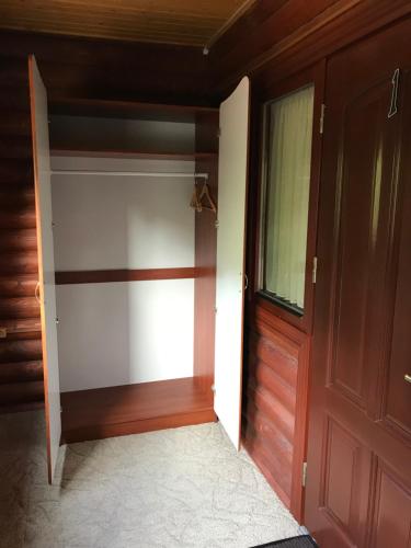 a room with a closet with a wooden door at Georgiy in Oryavchyk