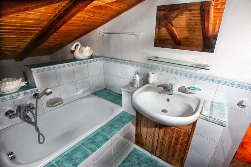 a bathroom with a bath tub and a sink at Mansarda sopra il mare in San Marco dʼAlunzio