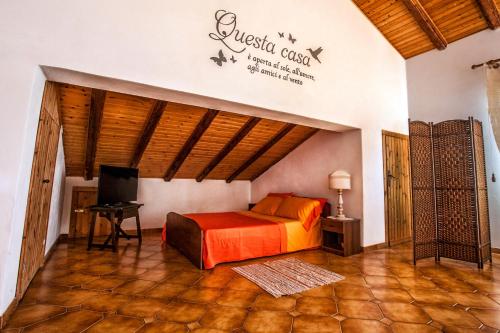 a bedroom with a bed and a tv in a room at Mansarda sopra il mare in San Marco dʼAlunzio