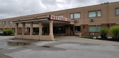 a westen inn sign in front of a building at Western Inn in Council Bluffs