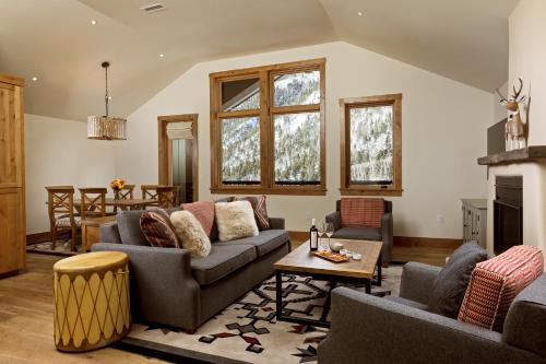 a living room with couches and a fireplace at The Blake at Taos Ski Valley in Taos Ski Valley