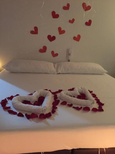 two hearts on a bed with towels on it at Hotel Marialu in Ocaña