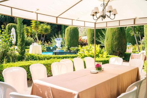 a table and chairs under a white tent at Casa de los Bates in Motril