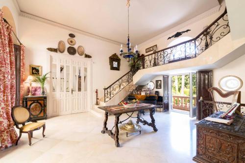 a living room with a table and a staircase at Casa de los Bates in Motril