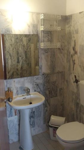 a bathroom with a sink and a toilet at Falfeira Apartments in Lagos