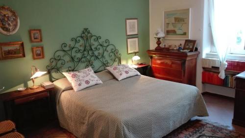 a bedroom with a bed with two pillows on it at La casa di Antonella in Nicolosi