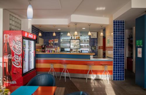 a bar in a restaurant with a soda machine at Hostel Soline in Portorož