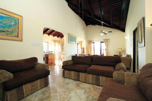 a living room with two couches and a couch at Sungold House Barbados in Saint Peter