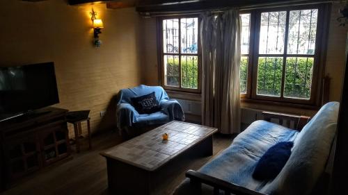 a living room with a couch and a coffee table at Universal Traveller's Hostel in San Carlos de Bariloche