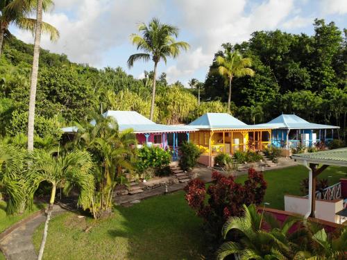 an aerial view of a resort with palm trees at Le Nid Tropical in Bouillante