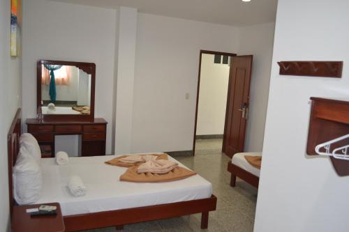 Säng eller sängar i ett rum på Hotel Villa Playa Grande
