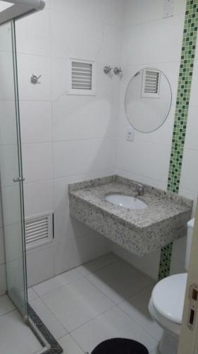 a bathroom with a sink and a toilet at Hotel Ville House Premium in Canoas
