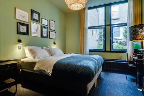 a bedroom with a bed and a window at SeventyFive in Amsterdam