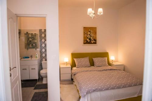 a bedroom with a bed and a bathroom at Reghin Guest House in Reghin