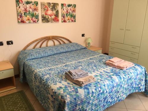 a bedroom with a bed with two bags on it at Via Acquedotto n. 66, Condominio "Le Piramidi" in Olbia