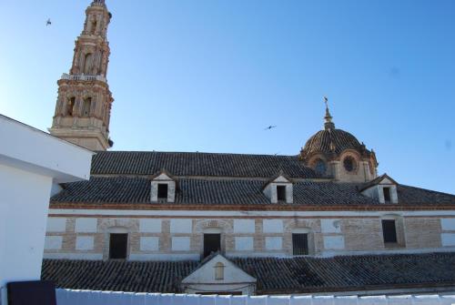 a building with a clock tower on top of it at El Patio del Limonero in Écija