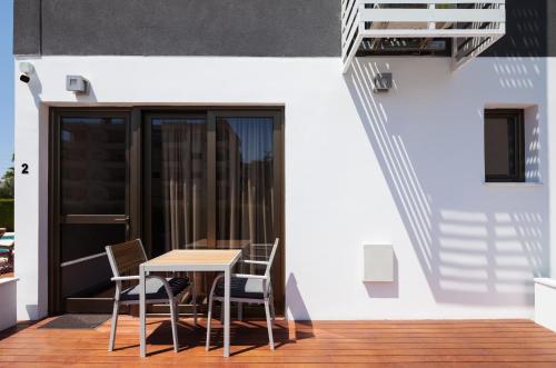 a table and chairs on the balcony of a building at The Jolo in Limassol